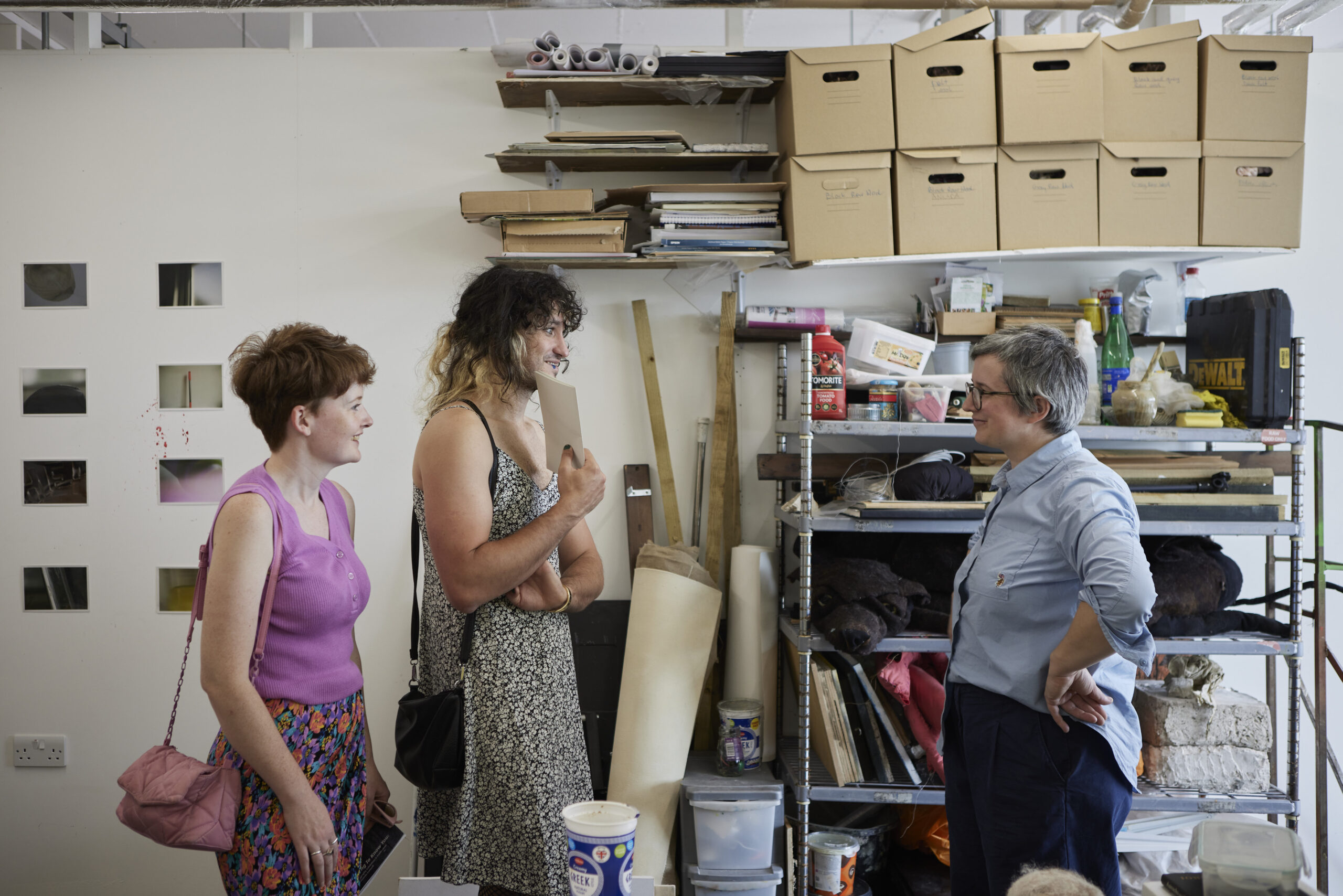 Three people in a London art studio talking.